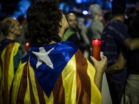 People hold cnadles during candle-lit demonstration and protests against the arrest of President of the Omnium Cultural Jordi Cuixart and pr...