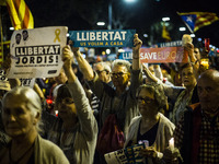People hold cnadles during candle-lit demonstration and protests against the arrest of President of the Omnium Cultural Jordi Cuixart and pr...