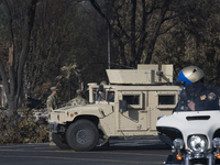 National Guard and local police are deployed to block access to area and neighborhood damaged during the recent devastating fire that hit Sa...