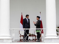 Indonesian President Joko Widodo (R) talks to Qatar's Emir Sheikh Tamim Bin Hamad al-Thani prior to their meeting at the presidential palace...