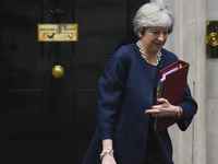 Britain's Prime Minister Theresa May leaves for the weekly Prime Minister Question (PMQ) session in the House of Commons, from Downing Stree...