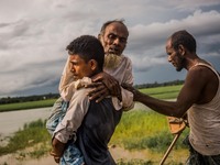 A son is taking his old father on the shoulder to the hospital with a purpose of his treatment at palongkhalhi in Cox's Bazar, Bangladesh on...
