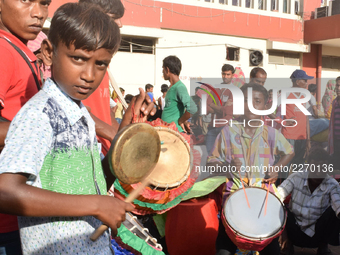 Indian traditional drum troupe, their instruments decorated with feathers, busk outside Sealdah railway station as they wait to be hired for...