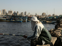 Palestinian fishermen fishes at the port in Gaza city in Gaza City on October 18, 2017 on the first day that fishermen will be allowed by Is...