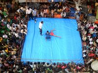 Indian amateur wrestlers participates in a Street side wrestling competition organised by the merchants of Burrabazar (Big Market) on the oc...