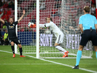 Benfica's Belgian goalkeeper Mile Svilar (C ) misses a safe after Manchester United's forward Marcus Rashford shoots to score during the UEF...