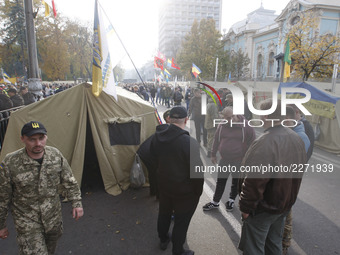 Ukrainian protesters are gathered in a tent camp that was erected outside parliament during a mass protest demanding a more forceful fight a...