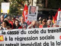Protestors march carrying a banner during a demonstration called by the General Confederation of Labour (CGT) French worker's union in Paris...