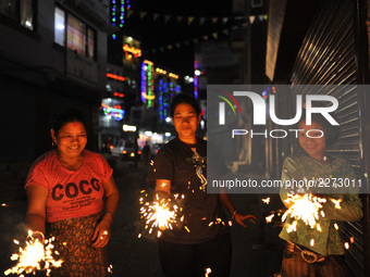 Nepalese people holding beautiful sparklers (fire crackers) in hands during Laxmi Puja as the procession of Tihar or Deepawali and Diwali ce...
