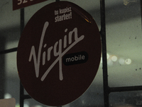 A sign outside a night shop advertising Virgin mobile is seen on 19 October, 2017. (