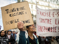 People hold up signs as they march in the Exitrans march for the rights of trans and intersex people on October 21, 2017 in Paris, France. (