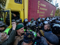 Protesters confront with the police which block the vehicle with sound-amplifying facilities in Kyiv, Ukraine, Oct.22, 2017. Dozens Ukrainia...