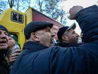 Protesters shout slogans as they confront with the police which block the vehicle with sound-amplifying facilities in Kyiv, Ukraine, Oct.22,...