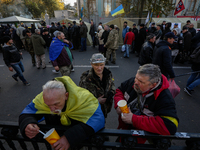 Protesters stay in a line to receive a food at their tent camp  in Kyiv, Ukraine, Oct.22, 2017. Dozens Ukrainians set up a tent camp in fron...