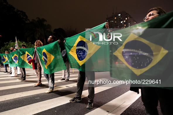Right-wing nationalists hold Brazilian flags in the Paulista Avenue during a protest against the President Dilma Rousseff, who is running fo...