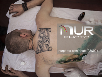 Pro-Russian militant, wounded by gunshot, is medicated in a secret hospital (Photo by Sandro Maddalena/NurPhoto)