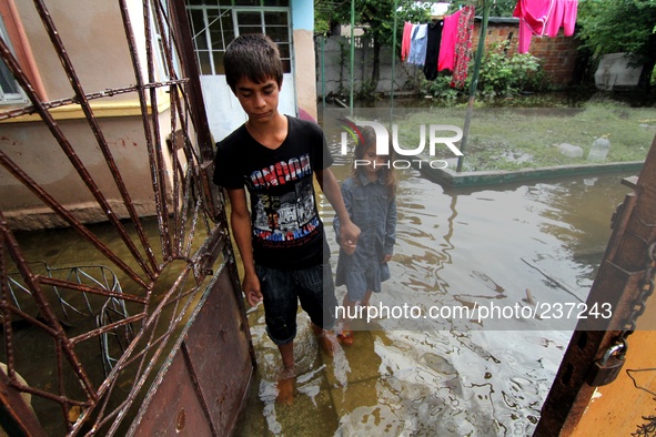 Children attent at a flooded house after a heavy flood near the town of Burgas. Heavy rain and storm hit the Black sea town of Burgas, some...