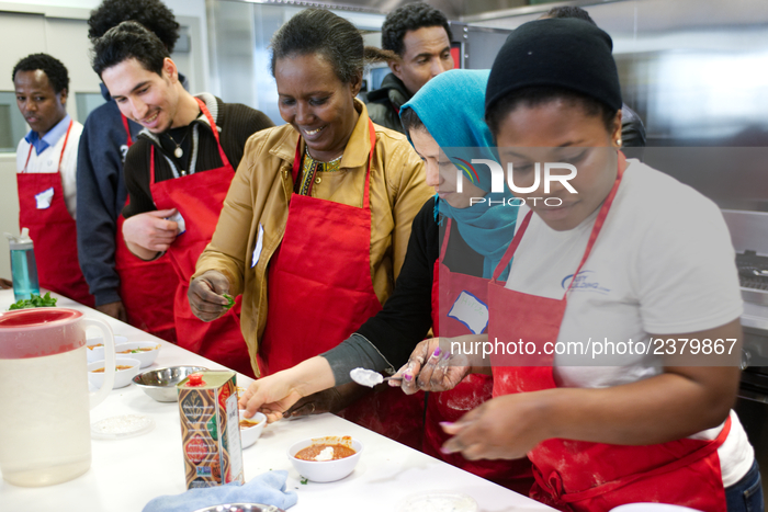 Philadelphia, PA, USA - January 6, 2016; Adult students and immigrants prepare food during an English-as-a-Second-Language course geared to...