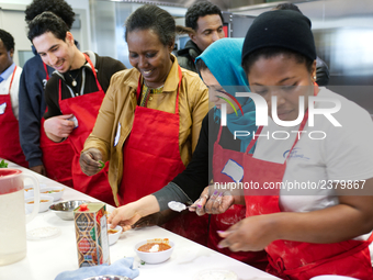 Philadelphia, PA, USA - January 6, 2016; Adult students and immigrants prepare food during an English-as-a-Second-Language course geared to...