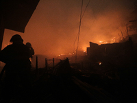 Firefighters try to contain a major fire that struck a slum located in the Campo Belo neighborhood on the Journalista Roberto Marinho Avenue...