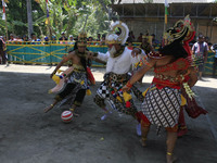 Javanese people a scramble the ball during a football game using dance costume reog in Yogyakarta, Indonesia, 14 September 2014. This event...