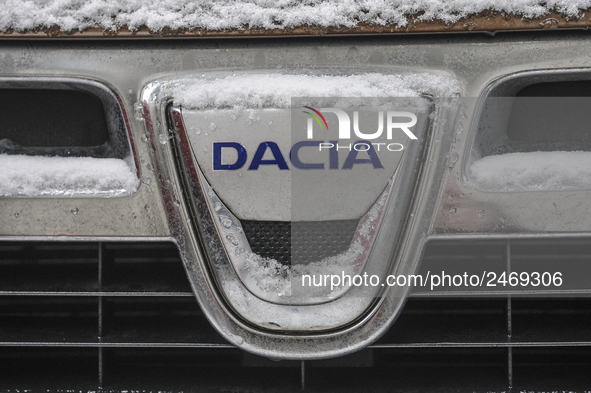 Snowflakes are seen on the badge of a Dacia car in Warsaw, Poland February 8, 2018. 