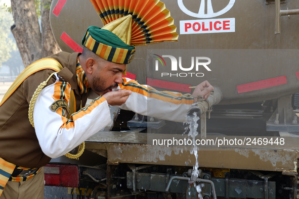 An Indo-Tibetan Border Police (ITBP) soldier drinks water after rehearsing for the upcoming 69th Republic Day Parade in New Delhi on January...