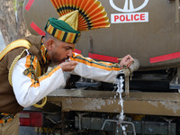 An Indo-Tibetan Border Police (ITBP) soldier drinks water after rehearsing for the upcoming 69th Republic Day Parade in New Delhi on January...