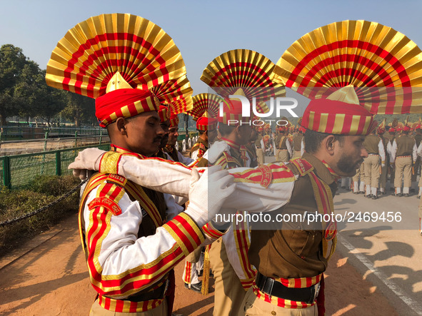 Sashastra Seema Bal (SSB) soldiers relax by massaging each other during their rehearsal for the Republic Day parade on a winter morning in N...