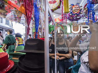 People observe the masks of an ornaments shop, prior to the celebration of the Carnival, in Sao Paulo, Brazil, on February 9, 2018. Accordin...