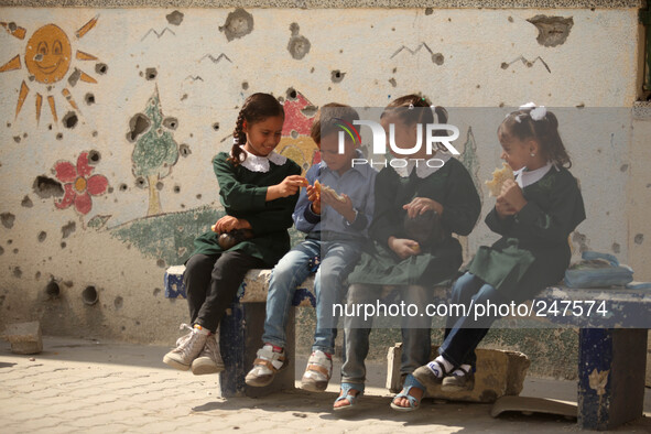 Palestinian students sit inside their school that witnesses said was shelled by Israel during its offensive, on the The second  day of the n...