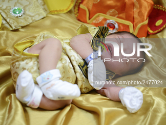 A newborn dressed in Chinese Emperor Costume at Paolo memorial hospital in Bangkok, Thailand, February 12, 2018. (