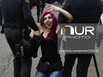 An animal rights activist is cleared by riot police while she tries to boycott 
