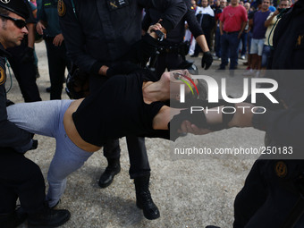 An animal rights activist is cleared by riot police while she tries to boycott 