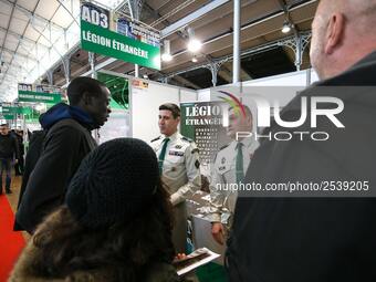 Jobseekers talk with members of French Foreign Legion recruiter staff at the 