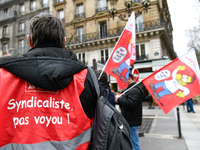 Striking Air France employees hold flags of French union CGT on March 12, 2018 in Paris, during a demonstration in front of the Palace of Ju...