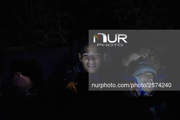 Nepalese Youths using mobile phones as lining in the night to pay the amount for the application submission for the Korean Language Test (KL...