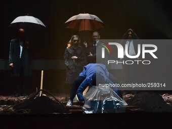 Jenny Konig and Robert Beyer (the couple under umbrella) and other cast members during a dress rehearsal of the world-renowned production of...
