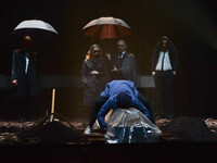 Jenny Konig and Robert Beyer (the couple under umbrella) and other cast members during a dress rehearsal of the world-renowned production of...