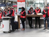 SNCF (French National Railway Corporation) employees speak with travellers to inform them on a platform of the Gare de l’Est railway station...