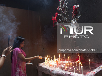 A Hindu woman offers prayers holding incense sticks at old Dhaka

 (