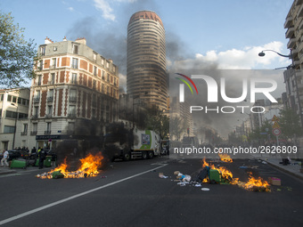 Police stand guard behind burning garbage bins as they face off with protesters near Paris Tolbiac university campus on April 20, 2018 in Pa...