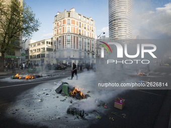 Police stand guard behind burning garbage bins as they face off with protesters near Paris Tolbiac university campus on April 20, 2018 in Pa...