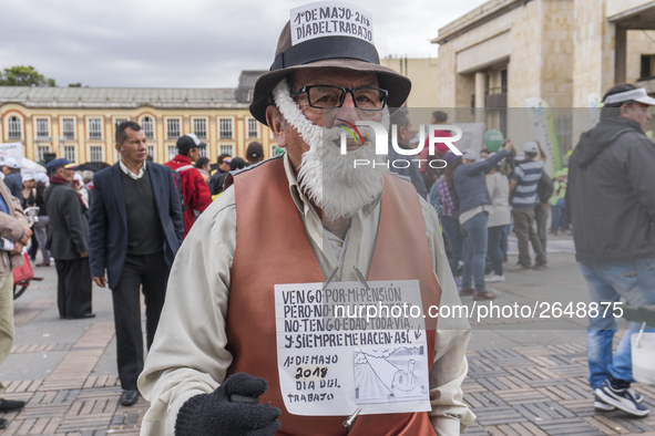 A person with posters at the Labor Day protest in Bogota, Colombia, on May 1, 2018. 