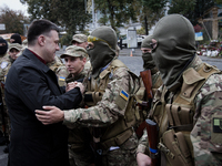 KIEV, UKRAINE - SEPTEMBER 30: Еhe leader of nationalist Svoboda political party Oleh Tyahnybok congratulates the Sich Battalion soldiers bef...