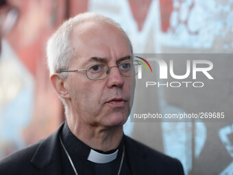 The Archbishop of Canterbury, Justin Welby Center), in visit to Belfast, stops at the Peace Wall. Belfast, Nortern Ireland. 2nd October 2014...