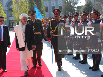 Afghan President Ashraf Ghani (C) inspects the guard of honour following Eid prayers at the Presidential Palace in Kabul on October 4, 2014....