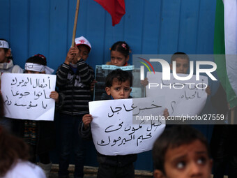 Palestinian women and children take part in a gathering to show solidarity with Palestinian refugees in Syria's main refugee camp Yarmuk, in...