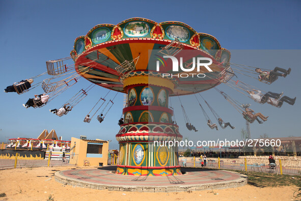 Palestinians enjoy in the city of Sharm Park for the Games in the central Gaza Strip on the third day of the Eid al-Adha. Muslims worldwide...