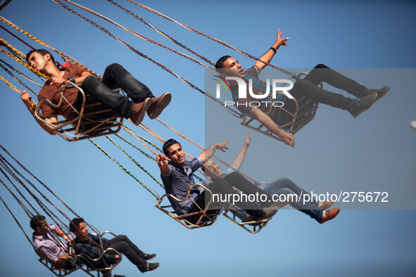 Palestinians enjoy in the city of Sharm Park for the Games in the central Gaza Strip on the third day of the Eid al-Adha. Muslims worldwide...